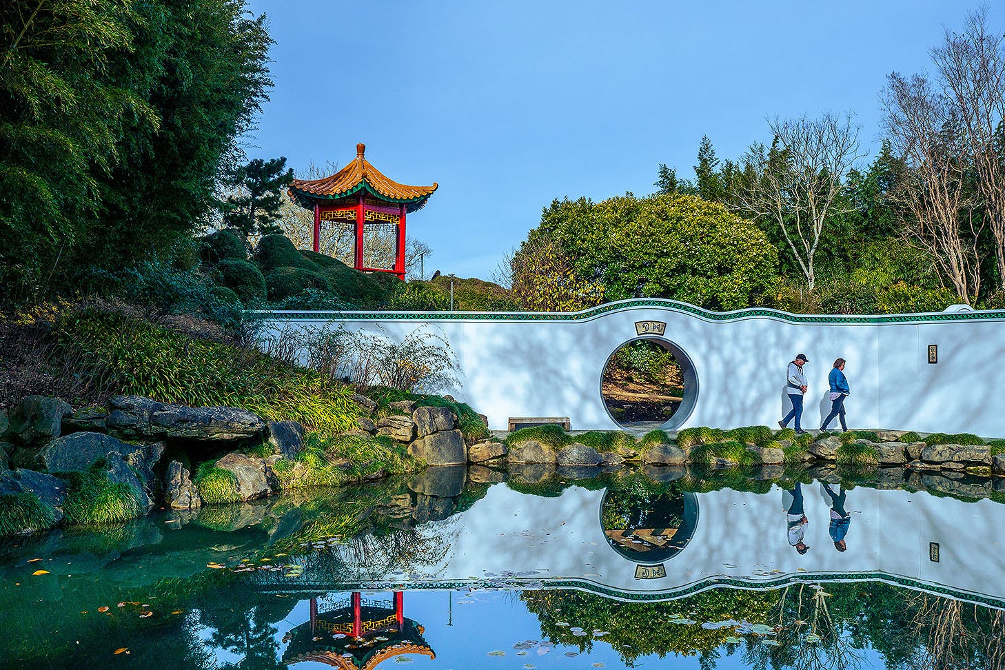 Two people wander about at Hamilton Gardens.